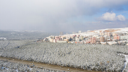 Aerial view of snowy forest and skyscrapers in Capital Of Turkey,ANKARA.