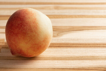 Peach, beautiful and tasty peach positioned on a rustic wooden surface, selective focus.