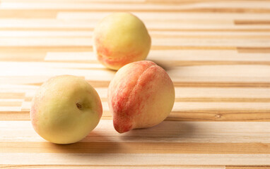 Peaches, beautiful and tasty peaches positioned on a rustic wooden surface, selective focus.