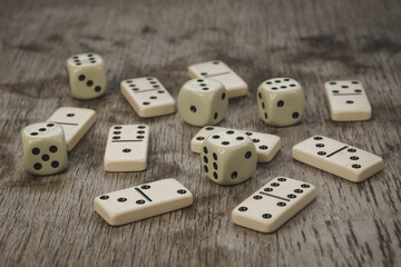 Dice and dominoes on wooden table, casino luck