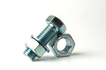 large bolt made of silver metal. Bolts, nuts and washers on a white background close up - obrazy, fototapety, plakaty