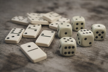 Dice and dominoes on wooden table, casino luck