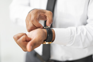 Obraz na płótnie Canvas Closeup of African American businessman wearing expensive wrist watch