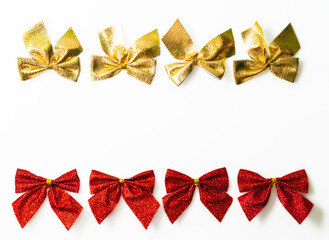 Red and golden shiny festive bow isolated on white background