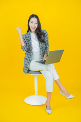 Portrait beautiful young asian woman smile with computer laptop