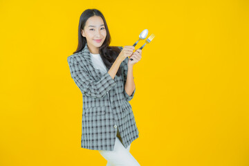 Portrait beautiful young asian woman smile with spoon and fork