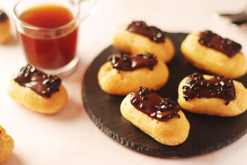 Traditional French dessert - eclairs with a cup of coffee