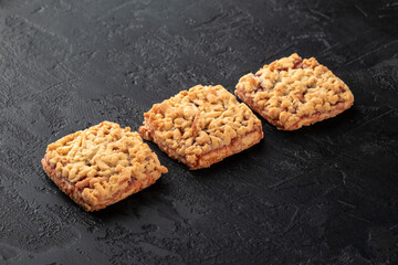 Healthy food concept. Homemade organic energy cookies on black slate stone background with copy space