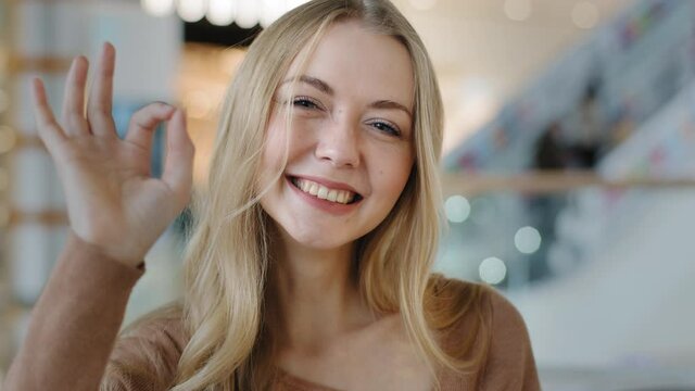 Close-up young girl smiling showing gesture sign OK caucasian woman satisfied with dental orthodontic service demonstrate symbol of support approval successful joyful millennial lady looking at camera