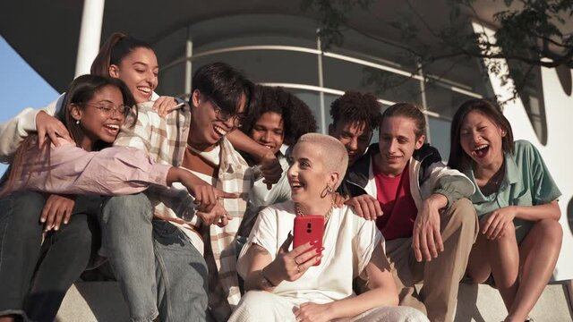 Group of happy teenager friends having fun sharing funny social media moments on a mobile phone app