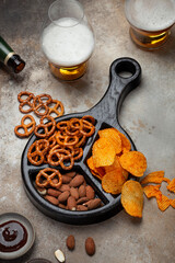 Fresh beer snacks assortment on wooden board