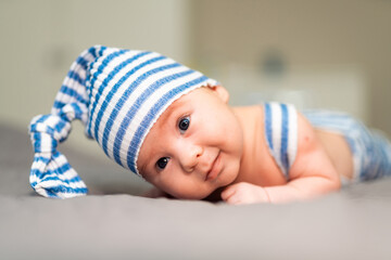 Newborn baby in a hat. Little boy in a blue suit
