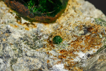 macro mineral stone Andradite on a black background