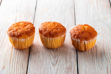 Freshly baked tasty bun on a white wooden table. Tasty baked goods straight from the bakery. White background.