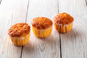 Freshly baked tasty bun on a white wooden table. Tasty baked goods straight from the bakery. White...