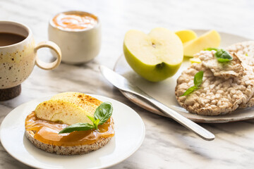 Crunchy buckwheat and rice snack with almond butter and apple on the table. Healthy sweet breakfast