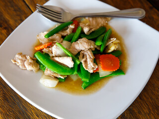 Stir Fry snow peas, Snap Peas or Sugar pea with pork and Oyster sauce (Thai name is Thua Lantao...