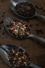 Various colored pepercorns on a dark background