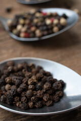 Various colored pepercorns on a dark background