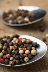 Various colored pepercorns on a dark background