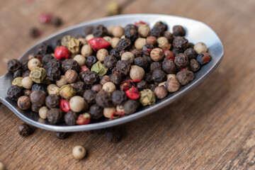 Various colored pepercorns on a dark background