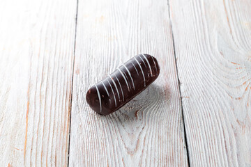 Chocolate candies on the white wooden background