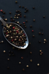 Various colored pepercorns on a dark background