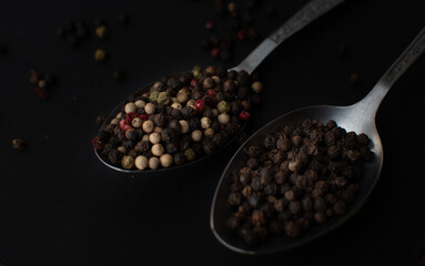 Various colored pepercorns on a dark background