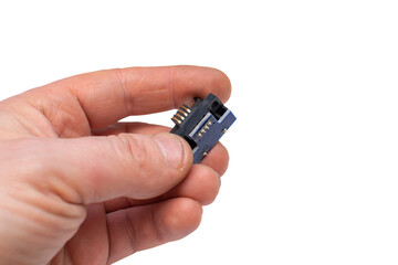 a pad with a chip, a microchip with copper contacts in a person hand on an isolated pure white background and an empty space for inserting text