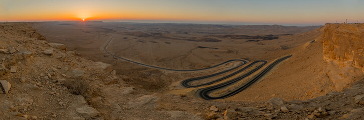 Sunrise panorama of winding road and Makhtesh Ramon, Negev Desert