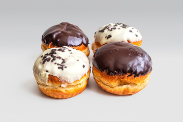 Donuts with chocolate and vanilla glaze on a light background