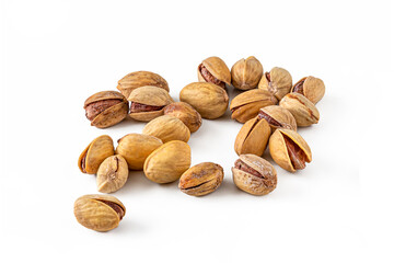 Few salted pistachio nuts with cracked shells on a white background