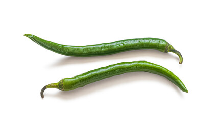 Two long pods of green hot pepper on a white background