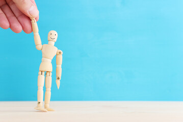 Concept image of happy mind and positive thinking. Wooden figure with smiling face