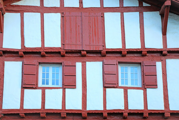 fachada de casa con ventanas rojas en ainhoa pueblo vasco francés francia 4M0A8653-as22