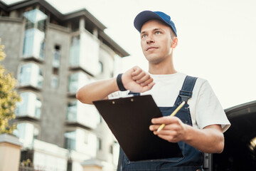 Fast delivery of goods and courier service driver.  Delivery of a box of products and goods to your home. Employee in uniform logistics company.