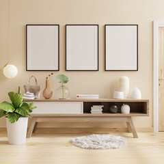 Black frame poster on cabinet in bright room with plants on cream wall background.