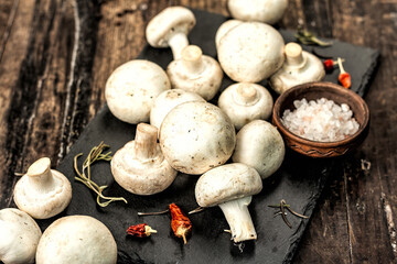 Fresh champignons with spices and herbs. Raw ingredient for cooking vegan food
