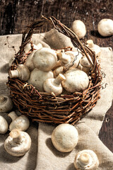 Fresh champignons in a basket. Raw ingredient for cooking vegan food