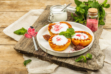 Grilled peach with yogurt, mint, and sweet pink sugar. Useful breakfast concept, healthy food