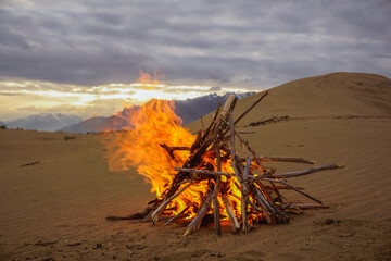 Bonfire on the sand dunes in the Chara desert