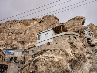 SYRIA. Maalul Monastery is located 60 km from Damascus. Nearby is the village of Kalamondin resembling an eagle's nest. The houses are built on the rocks by steps.