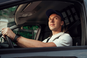 The driver of the courier service. Employee in uniform logistics company.  Fast delivery of the...