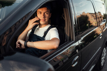 Fast delivery of the goods. The driver of the courier service. Employee in uniform logistics...