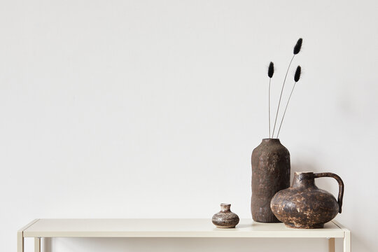 Elegant minimalist interior design with metal shelf and vintage vases. Copy space. Template.