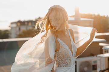 Wind in hair, Young blond bride, wedding makeup, happy. Beautiful woman posing in white wedding...