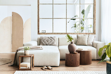Interior design of living room with stylish modular beige sofa, wooden coffee tables, plants,...