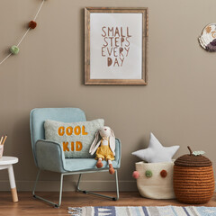 Stylish scandinavian kid room interior with toys, teddy bear, plush animal toys, mint armchair,...