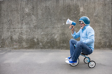 Fototapeta Funny businessman driving retro trike outdoor obraz