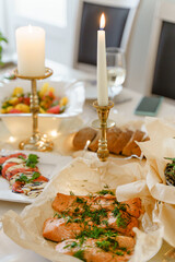 Festive table with food, wine and candles.